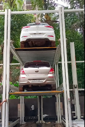 Three level stack parking with two cars raised above the driveway
